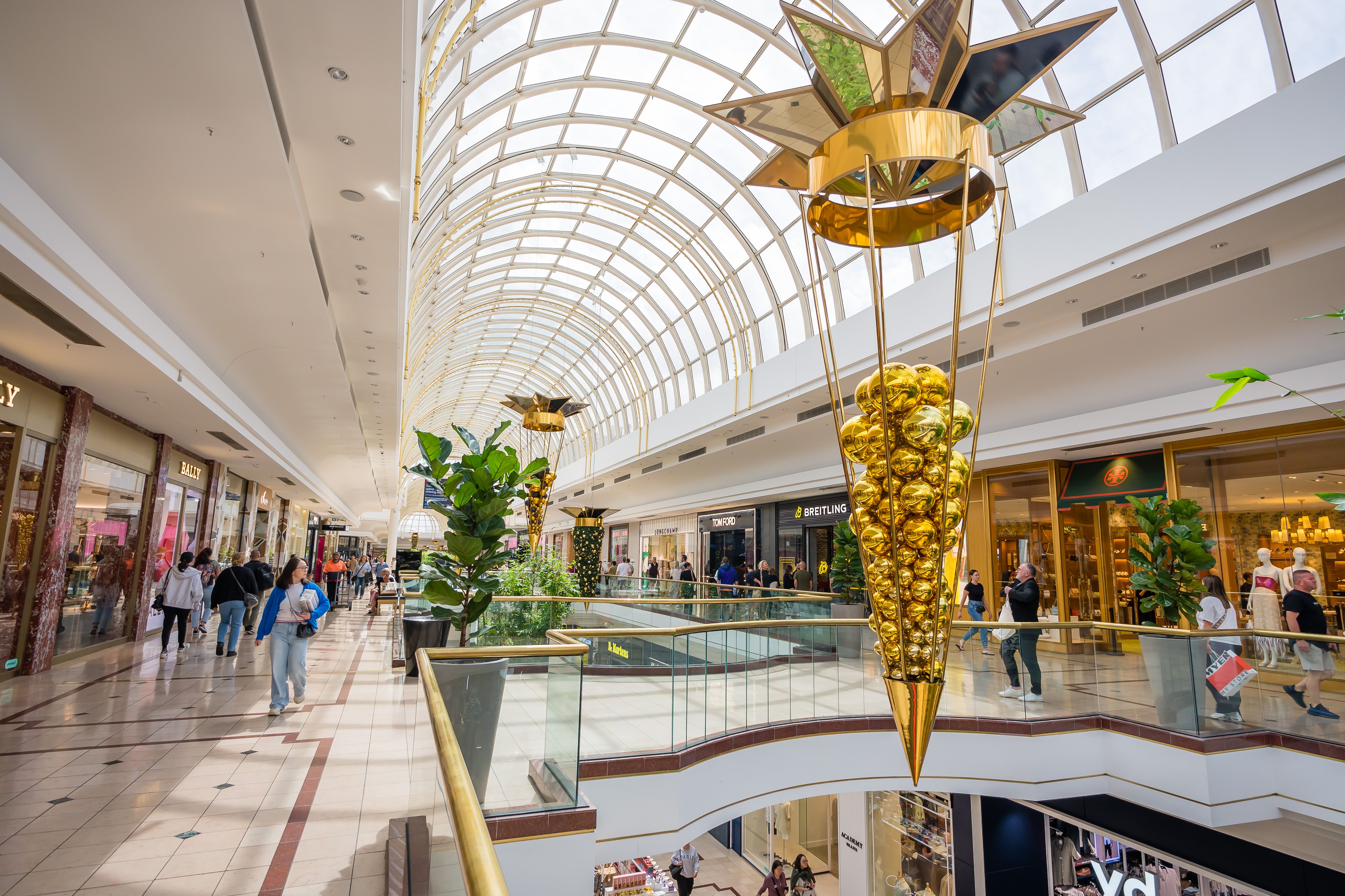 Shoppers inside an upscale retail shopping center