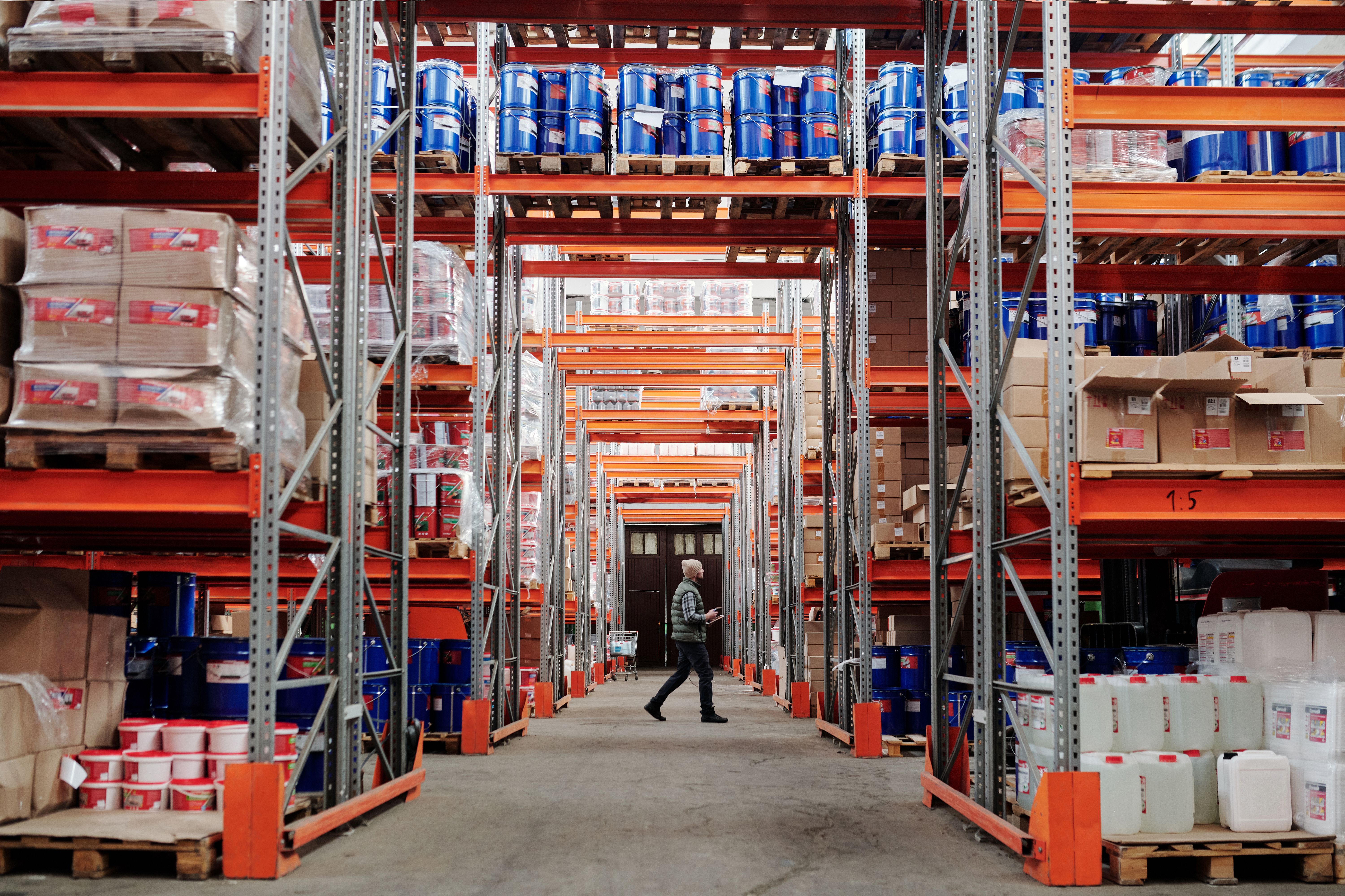 Worker walking through an industrial distribution warehouse